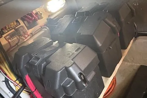 Slide: The Image of Battery compartment of a 2006 Mainship 400 Trawler, featuring multiple secured batteries. - 10