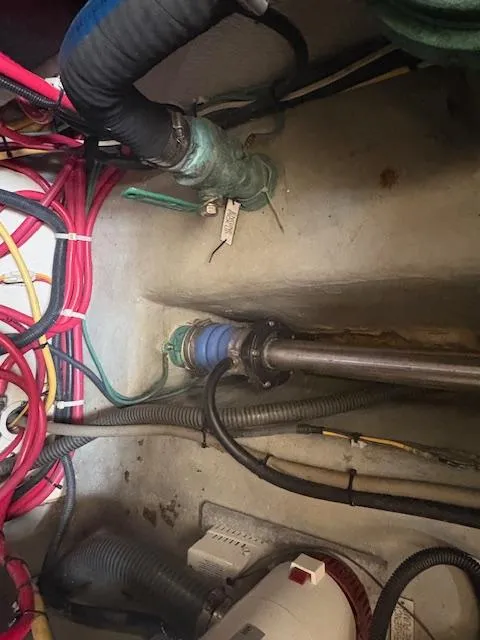 Slide: The Image of Engine compartment of a 2006 Mainship 400 Trawler with visible wiring and plumbing. - 12