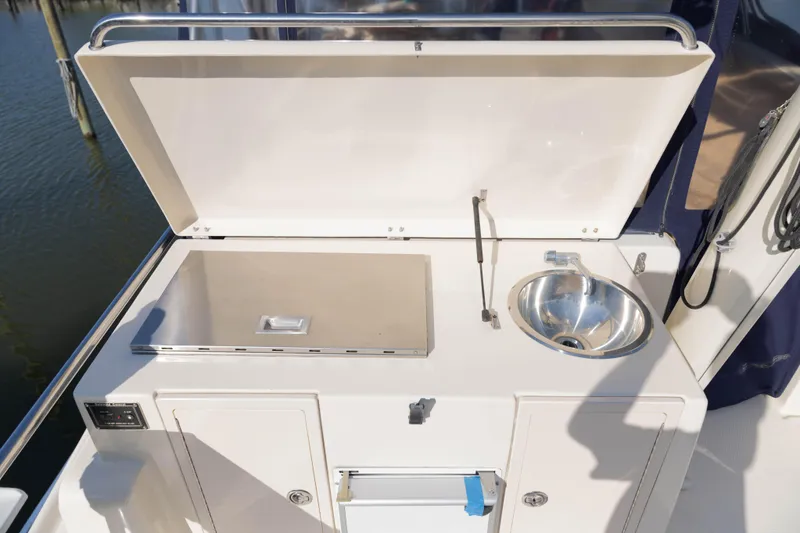 Slide: The Image of Outdoor sink and grill on 2006 Mainship 400 Trawler yacht deck. - 24