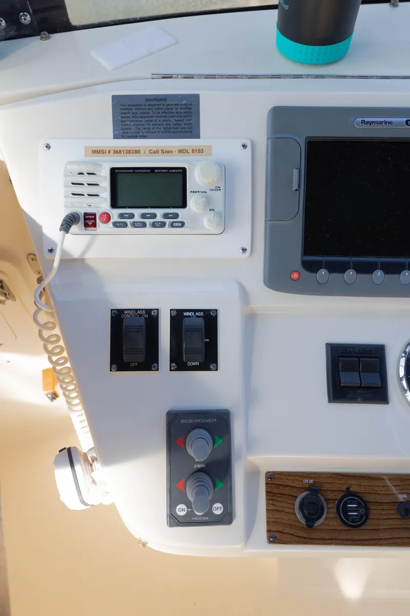 Slide: The Image of Control panel of a 2006 Mainship 400 Trawler with navigation and communication equipment. - 28