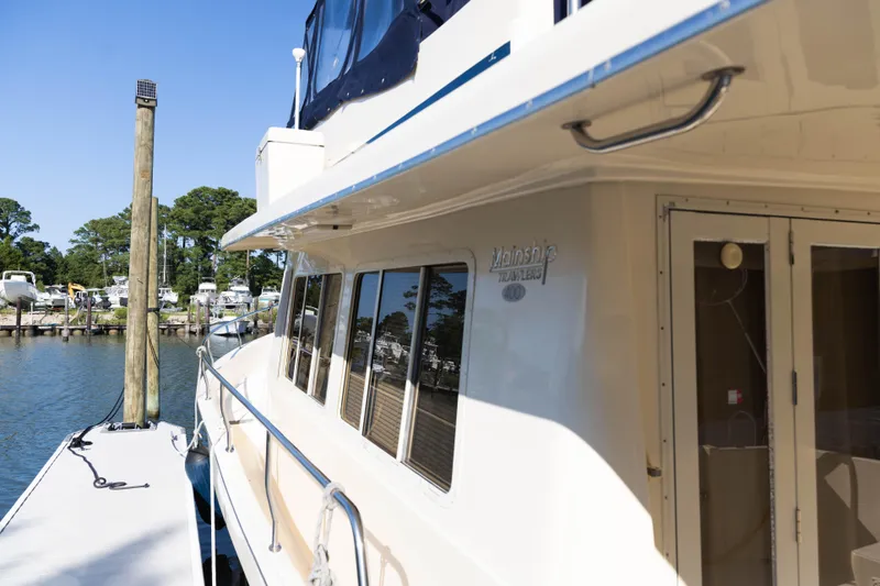 Slide: The Image of 2006 Mainship 400 Trawler docked at marina, sunny day, clear blue sky. - 3