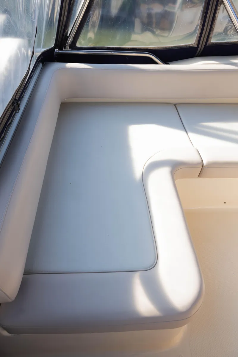 Slide: The Image of 2006 Mainship 400 Trawler interior with white cushioned seating. - 31