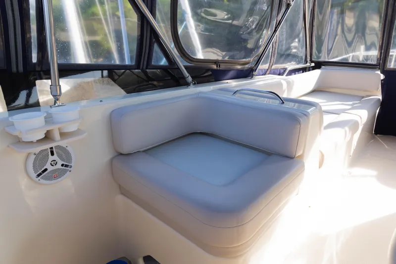 Slide: The Image of 2006 Mainship 400 Trawler interior with cushioned seating and clear windows. - 36