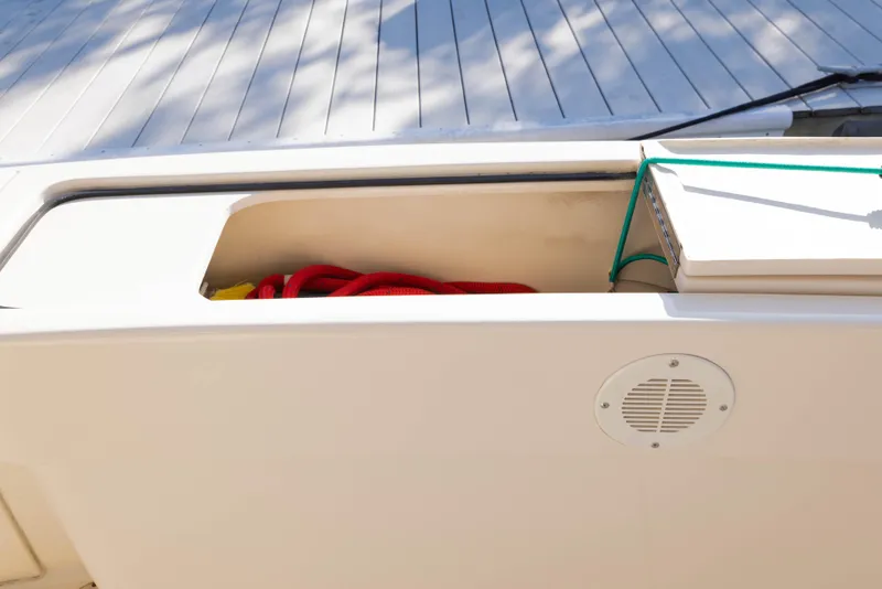 Slide: The Image of Storage compartment on 2006 Mainship 400 Trawler with red rope and speaker. - 40