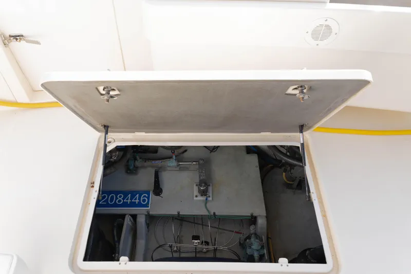 Slide: The Image of Open engine compartment of 2006 Mainship 400 Trawler, showing mechanical components and wiring. - 42