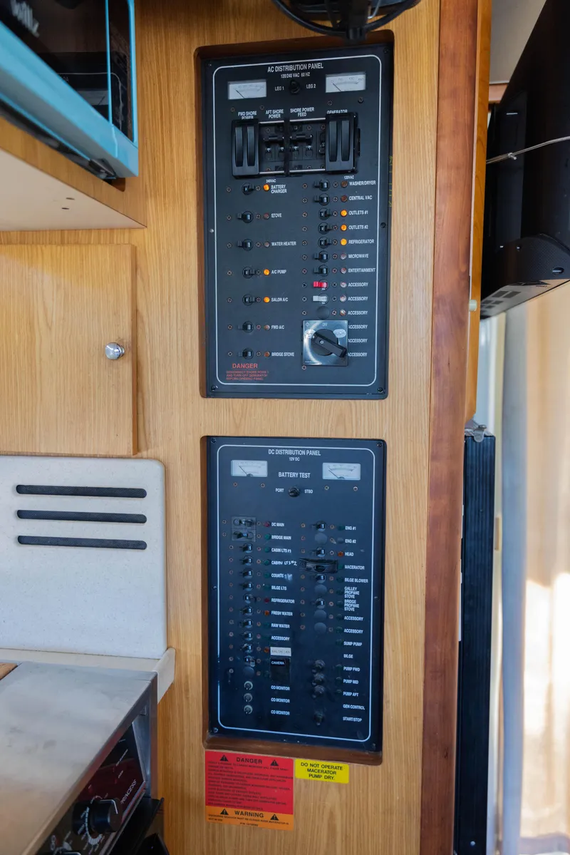 Slide: The Image of Electrical control panels on a 2006 Mainship 400 Trawler boat interior. - 47