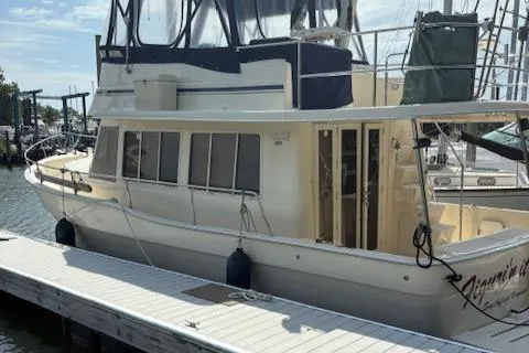 Slide: The Image of 2006 Mainship 400 Trawler docked at marina, side view. - 6