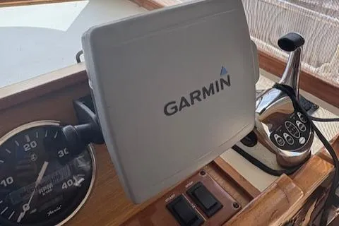 Slide: The Image of Garmin navigation system on 2006 Mainship 400 Trawler dashboard with controls and speedometer. - 9