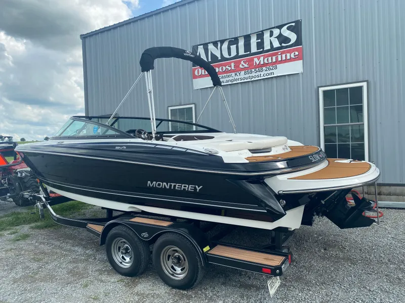 Slide: The Image of 2018 Monterey 224FS boat on trailer outside Anglers Outpost & Marine. - 10