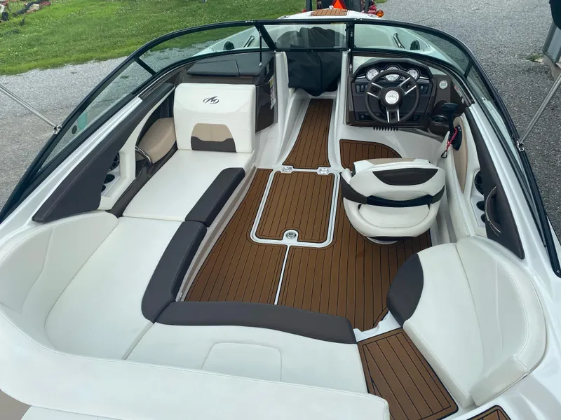 Slide: The Image of 2018 Monterey 224FS boat interior with sleek seating and modern dashboard design. - 11