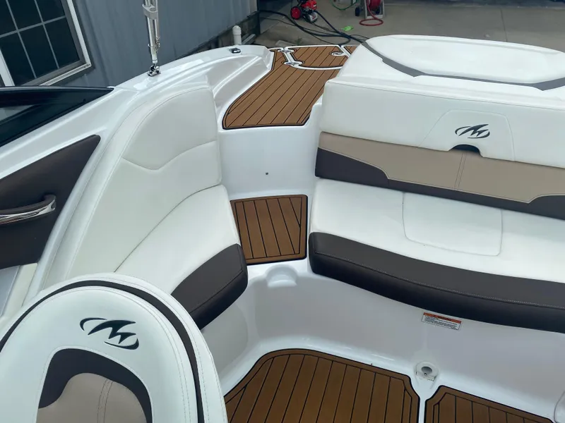 Slide: The Image of 2018 Monterey 224FS boat interior with white and brown seating, teak-style flooring. - 18