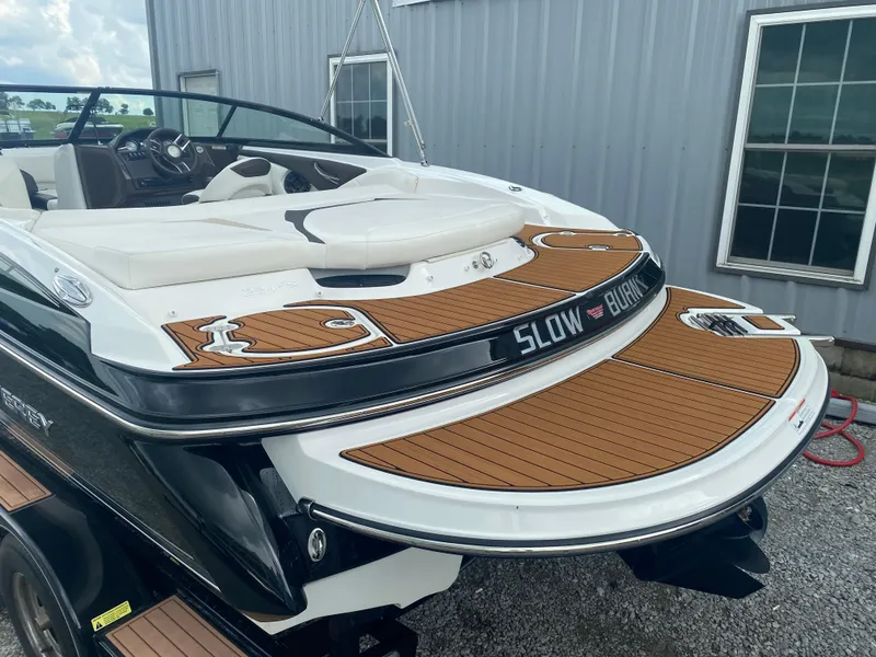 Slide: The Image of 2018 Monterey 224FS boat with teak deck, parked near a building. - 7