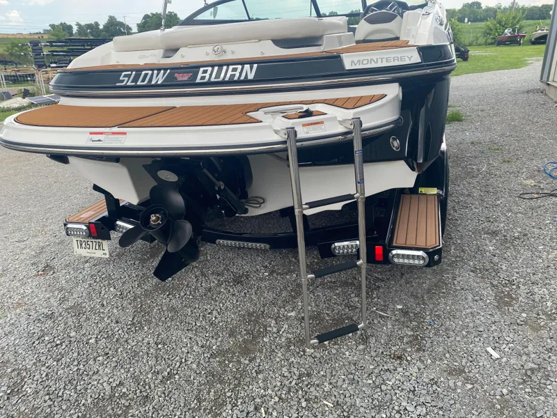 Slide: The Image of 2018 Monterey 224FS boat rear view with ladder and propeller on gravel surface. - 9