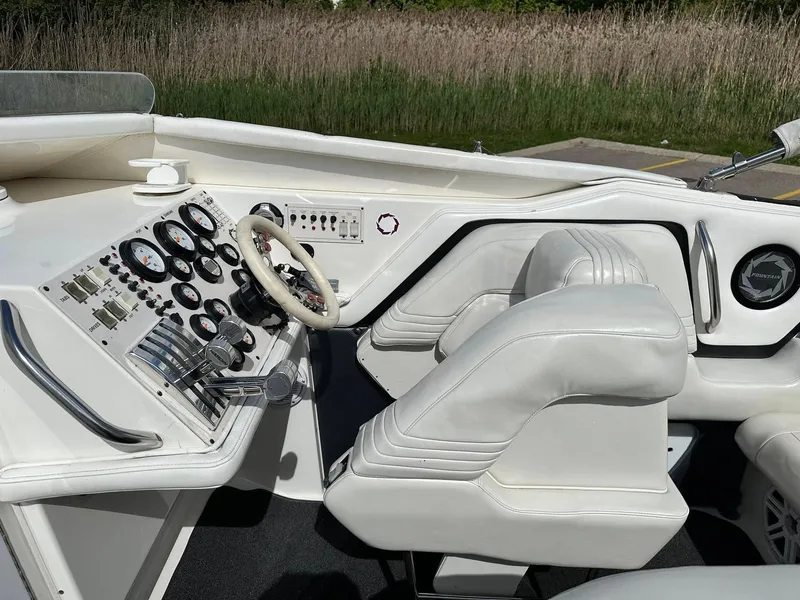 Slide: The Image of 1994 Fountain 35 Lightning boat cockpit with white leather seats and control panel. - 16
