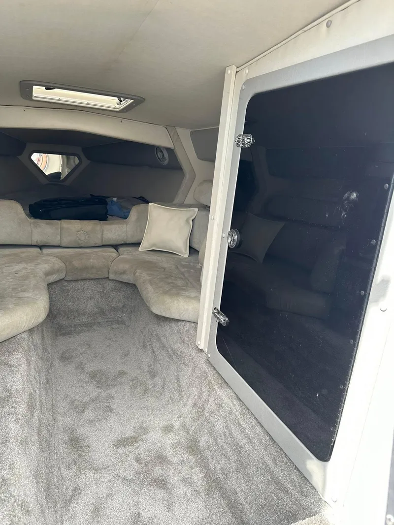 Slide: The Image of Interior of a 1994 Fountain 35 Lightning boat with plush seating and carpeted floor. - 21