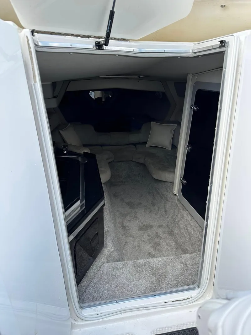 Slide: The Image of Interior view of a 1994 Fountain 35 Lightning boat, featuring a cozy cabin space. - 22