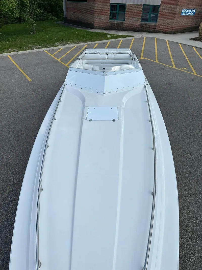 Slide: The Image of 1994 Fountain 35 Lightning boat parked on asphalt with yellow lines. - 6