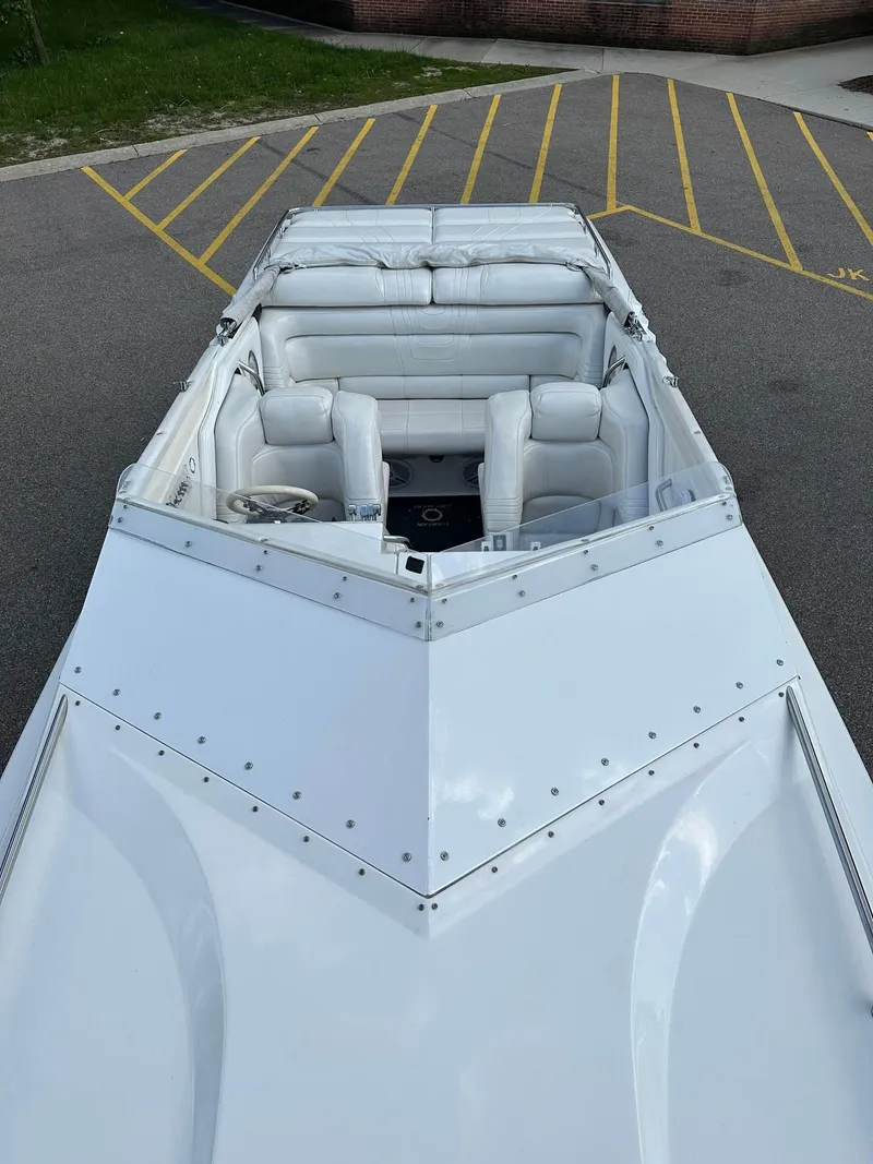 Slide: The Image of 1994 Fountain 35 Lightning boat with white interior, parked on asphalt with yellow lines. - 9