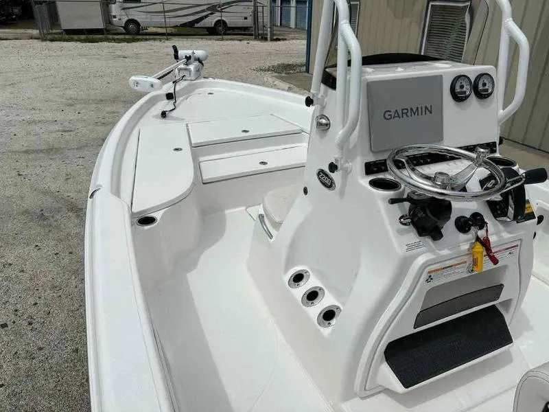 Slide: The Image of 2026 Blazer PureBay 2200 boat interior with Garmin navigation system and steering console. - 11