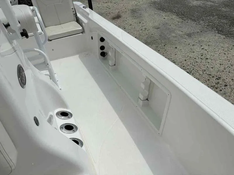 Slide: The Image of 2026 Blazer PureBay 2200 boat interior with seating and cup holders. - 19