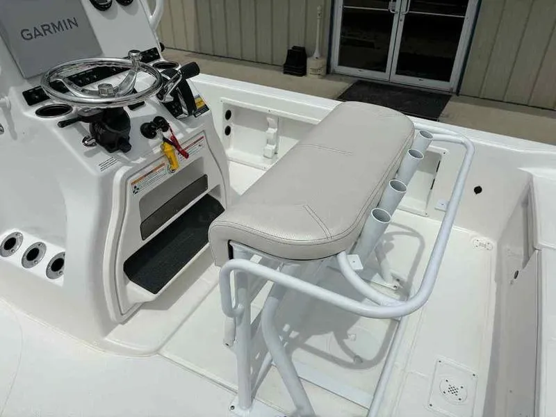 Slide: The Image of 2026 Blazer PureBay 2200 boat interior with steering console and cushioned seating. - 22
