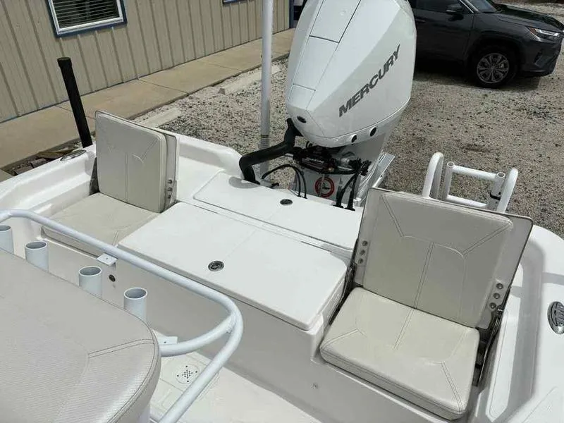 Slide: The Image of 2026 Blazer PureBay 2200 boat with Mercury engine, featuring white seating and rod holders. - 24