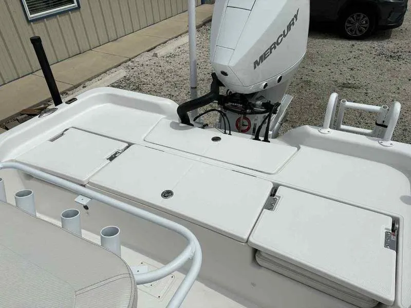 Slide: The Image of 2026 Blazer PureBay 2200 boat with Mercury engine, featuring storage compartments and rod holders. - 25