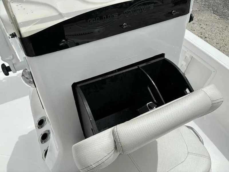 Slide: The Image of 2026 Blazer PureBay 2200 boat console with storage compartment and cushioned seat. - 27