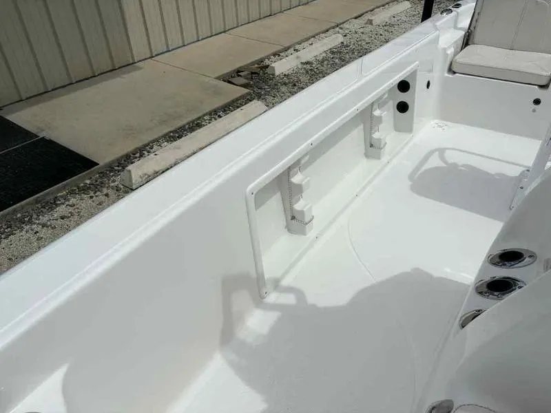 Slide: The Image of 2026 Blazer PureBay 2200 boat interior, featuring white seating and storage compartments. - 9