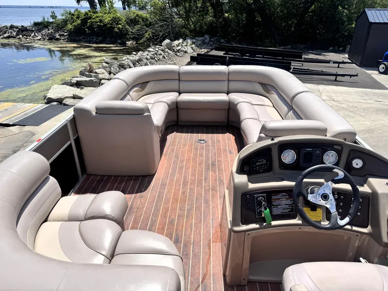 Slide: The Image of 2013 Crest Classic 230SLR pontoon boat with spacious seating and wooden deck by the water. - 10