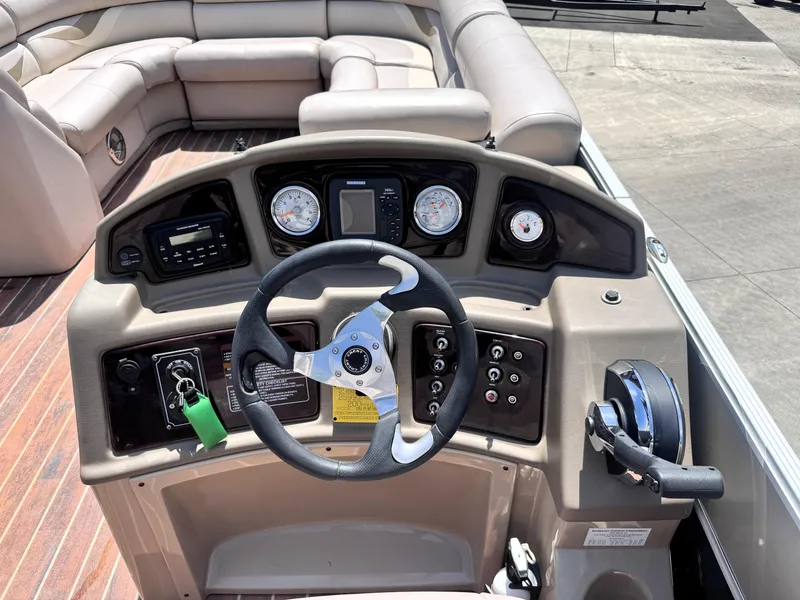 Slide: The Image of 2013 Crest Classic 230SLR boat dashboard with steering wheel and controls. - 11