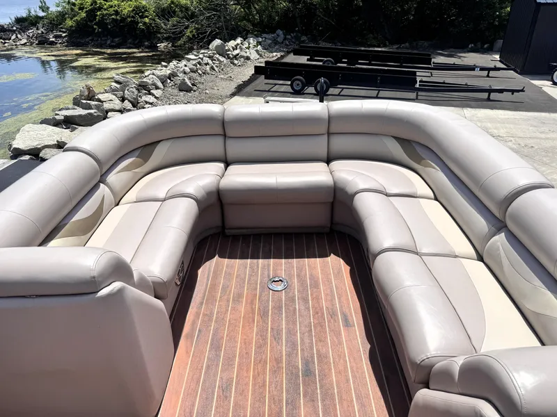 Slide: The Image of Luxurious seating on 2013 Crest Classic 230SLR pontoon boat, docked by rocky shoreline. - 14