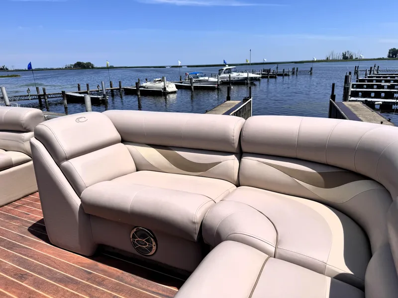 Slide: The Image of Luxurious seating on a 2013 Crest Classic 230SLR pontoon boat by a serene lake. - 16