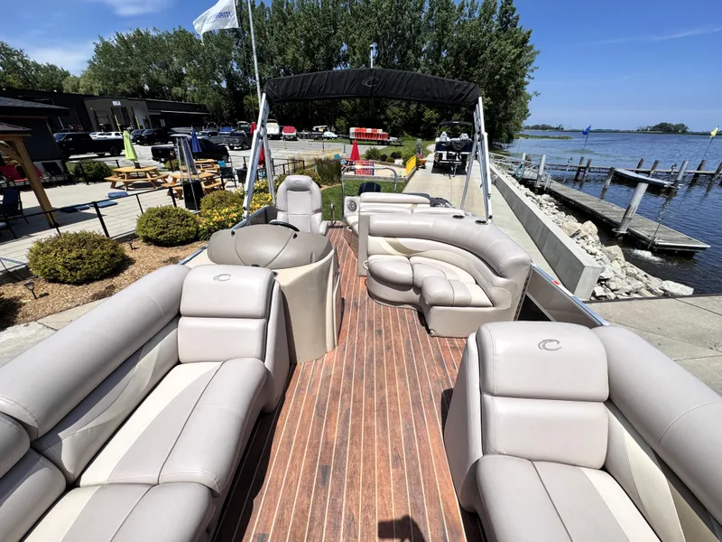 Slide: The Image of 2013 Crest Classic 230SLR pontoon boat with spacious seating, docked by a scenic lakeside. - 18