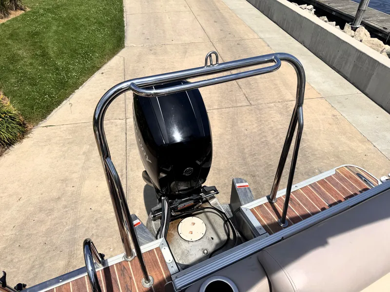 Slide: The Image of 2013 Crest Classic 230SLR boat with Mercury outboard motor on a wooden deck. - 20