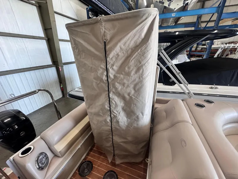 Slide: The Image of 2013 Crest Classic 230SLR boat interior with covered console in storage facility. - 9