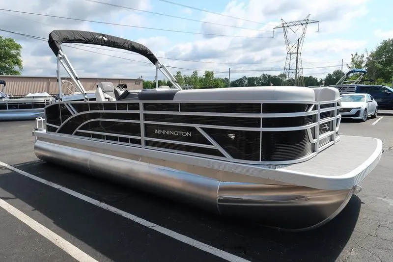 Slide: The Image of 2026 Bennington S Swingback 22 SSB pontoon boat parked in a lot, featuring sleek design and modern amenities. - 13