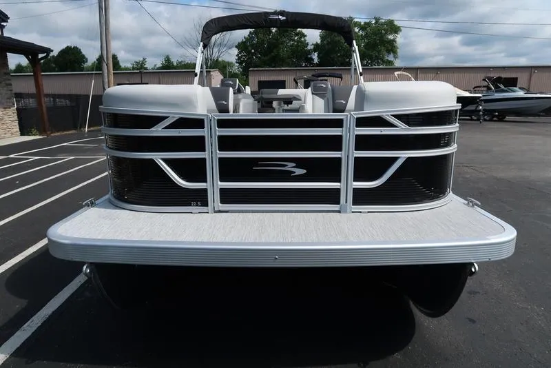 Slide: The Image of 2026 Bennington S Swingback 22 SSB pontoon boat, front view in a parking lot. - 15