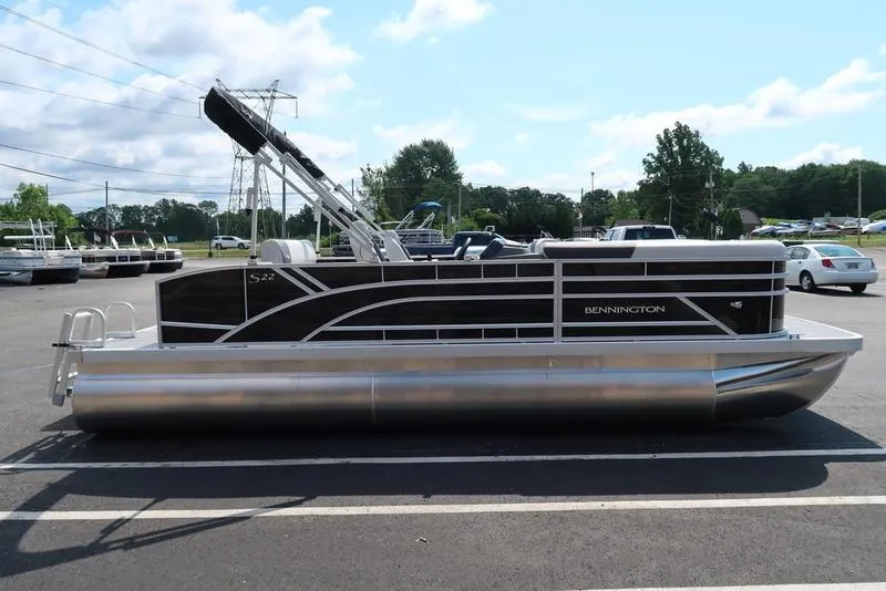 Slide: The Image of 2026 Bennington S Swingback 22 SSB pontoon boat parked outdoors. - 17