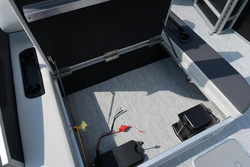 Slide: The Image of 2026 Bennington S Swingback 22 SSB storage compartment with wiring and battery setup. - 32