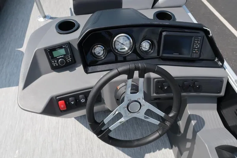 Slide: The Image of 2026 Bennington S Swingback 22 SSB dashboard with steering wheel, gauges, and controls. - 36
