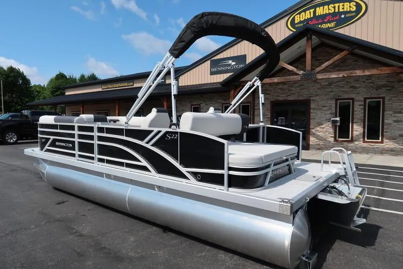 Slide: The Image of 2026 Bennington S Swingback 22 SSB pontoon boat parked outside dealership. - 9