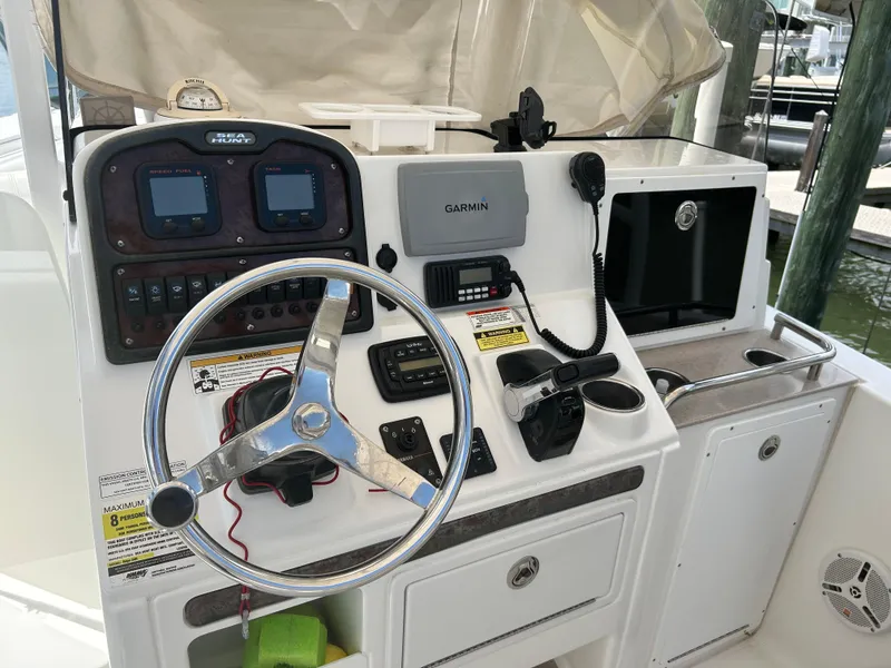 Slide: The Image of Control panel of a 2013 Sea Hunt Edge 24 boat with steering wheel and navigation equipment. - 10