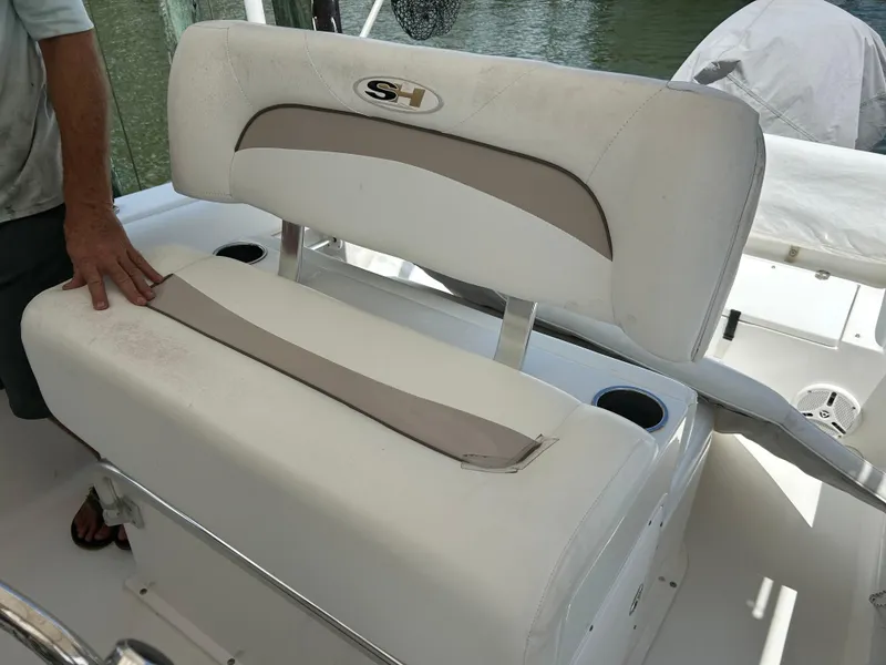 Slide: The Image of 2013 Sea Hunt Edge 24 boat seat with cup holders and handrail. - 11