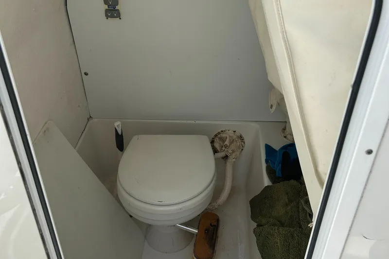 Slide: The Image of Compact marine toilet in a 2013 Sea Hunt Edge 24 boat cabin. - 15