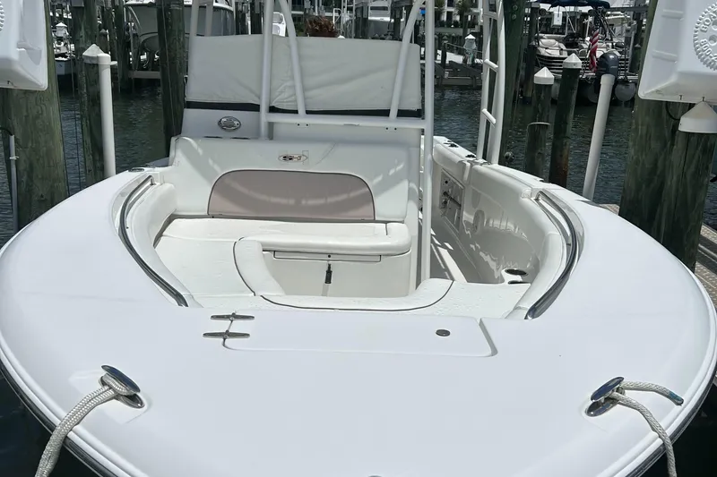 Slide: The Image of 2013 Sea Hunt Edge 24 boat docked, featuring spacious seating and sleek design. - 5