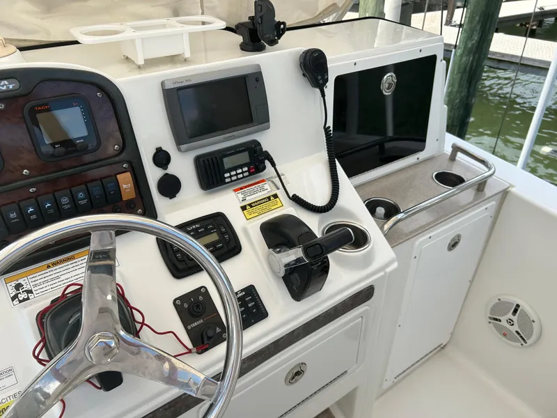 Slide: The Image of 2013 Sea Hunt Edge 24 boat dashboard with steering wheel and navigation controls. - 7