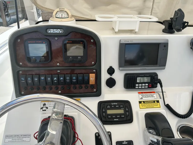 Slide: The Image of 2013 Sea Hunt Edge 24 boat dashboard with navigation and control instruments. - 8