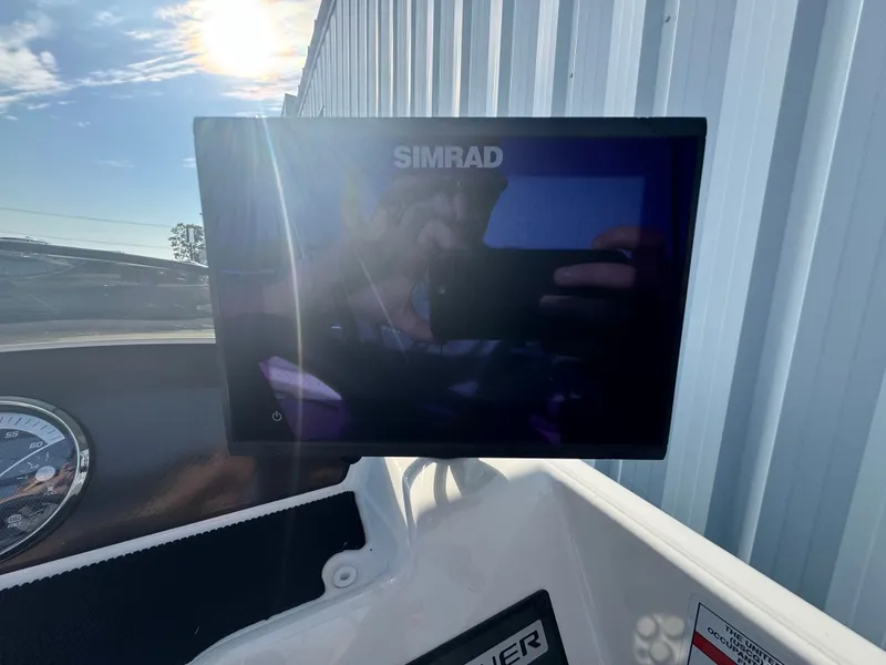 Slide: The Image of Simrad display on 2022 Bayliner Element M17 boat dashboard, reflecting sunlight. - 10
