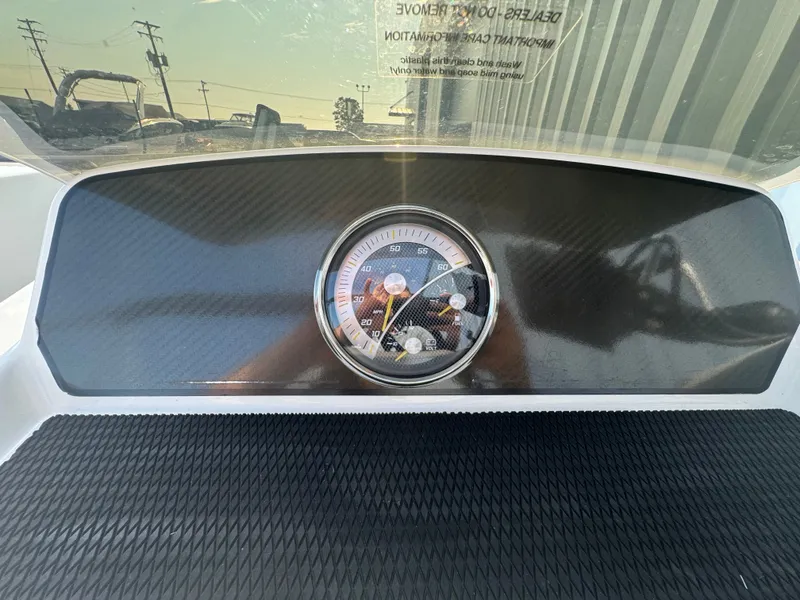 Slide: The Image of Dashboard of 2022 Bayliner Element M17 boat with speedometer and carbon fiber finish. - 11